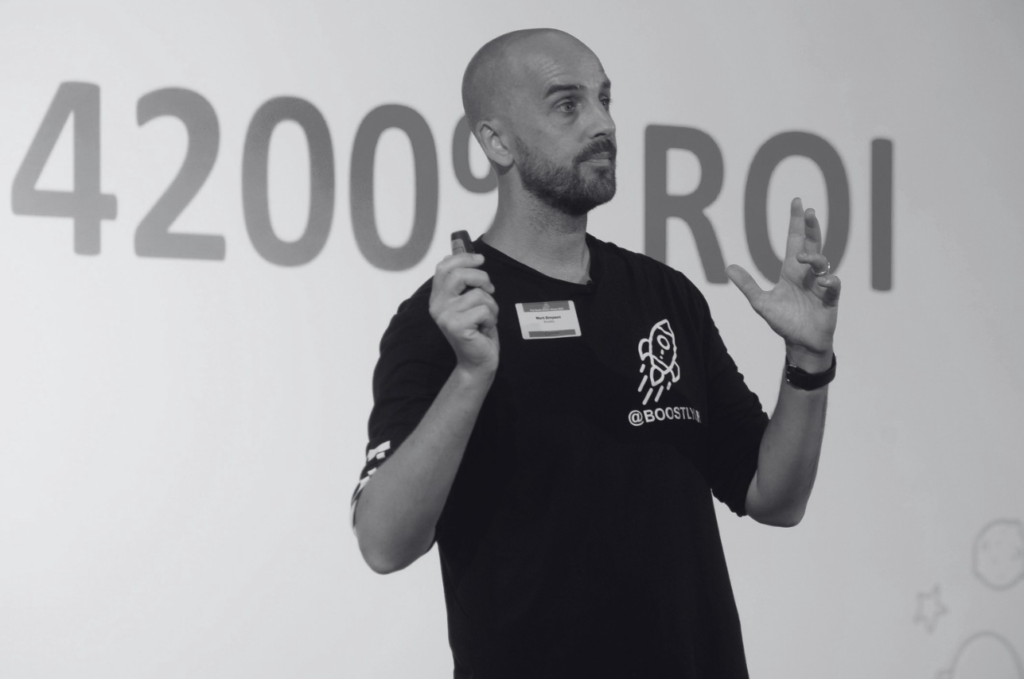 Person presenting with hands raised.