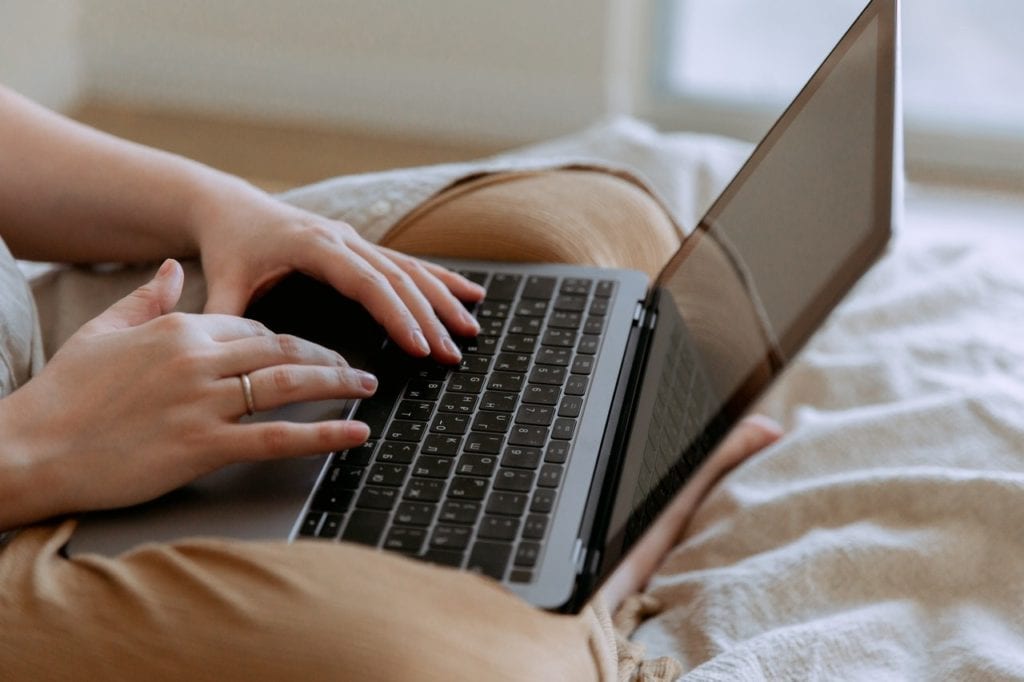 Blogging and content marketing. A woman typing on a laptop