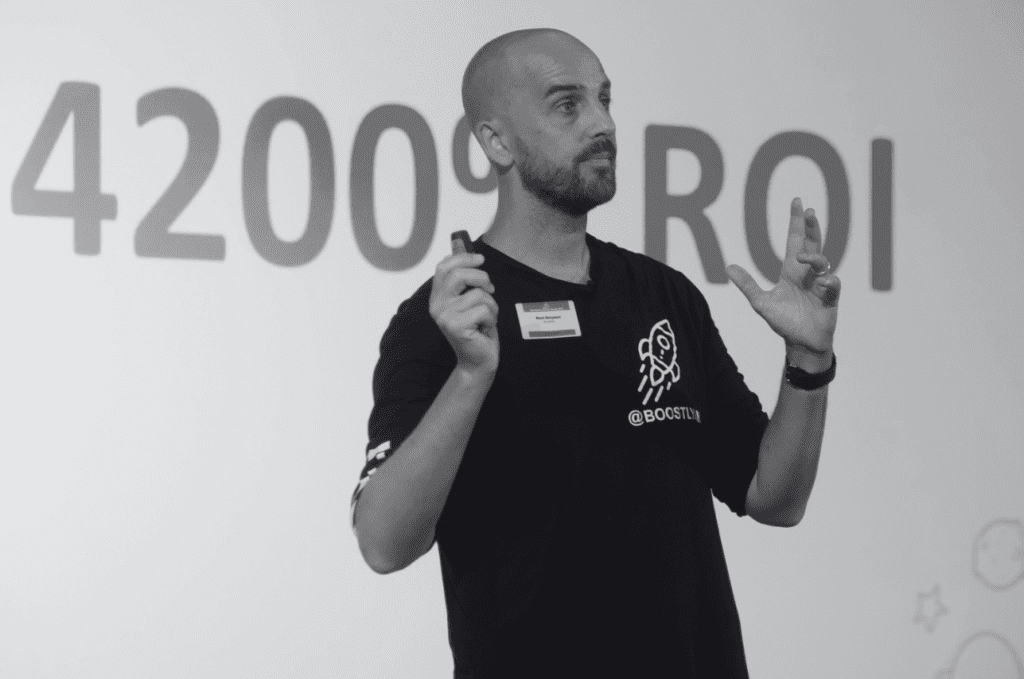 Person presenting with hands raised.